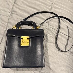 Elegant vintage Black Leather Handbag with Gold Accents